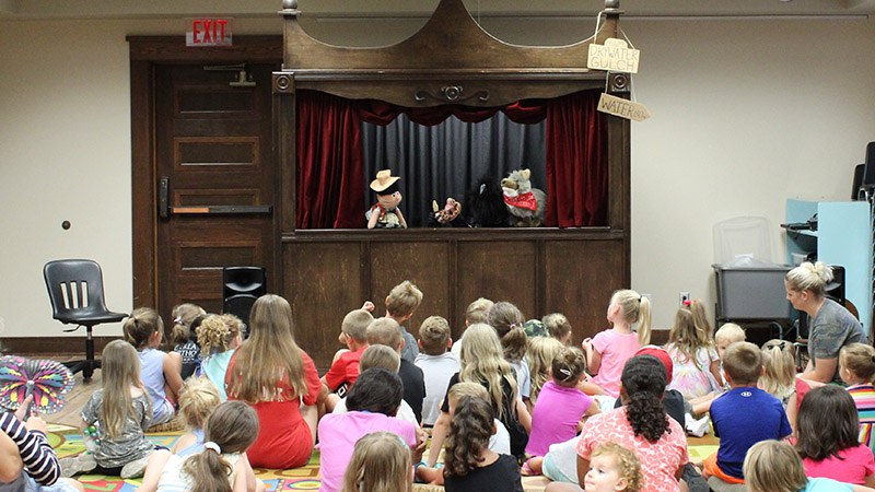 Photo of children watching a puppet show