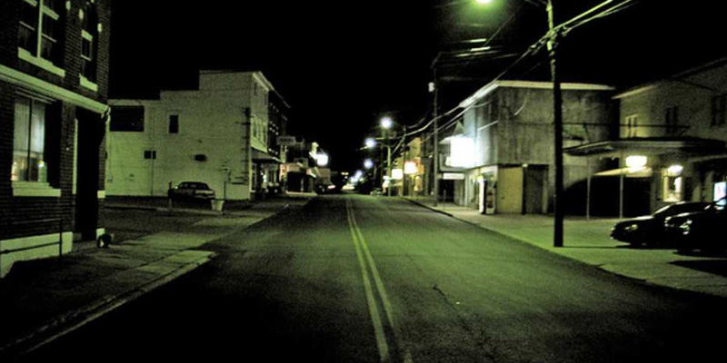 Nighttime photo of a quiet, dark street in a small town