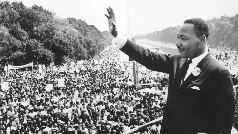 Black and white photo of Martin Luther King, Jr., delivering his iconic speech in front of the Lincoln Memorial.