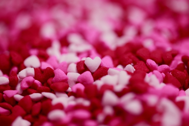 Up-close photo candy heart sprinkles in red, white, and pink