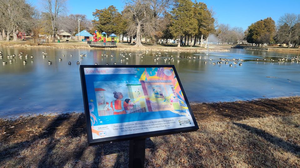 Outdoor photo of Lakeside Park in Pittsburg, Kansas showing a StoryWalk board