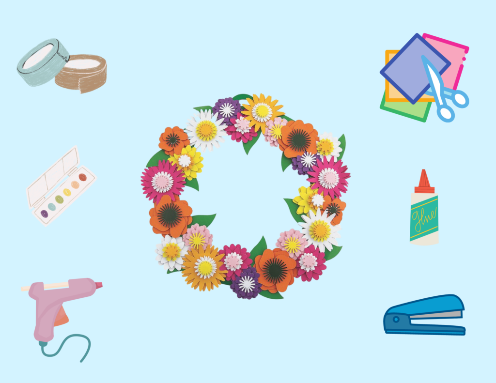 Blue background with paper flower wreath and various craft supplies