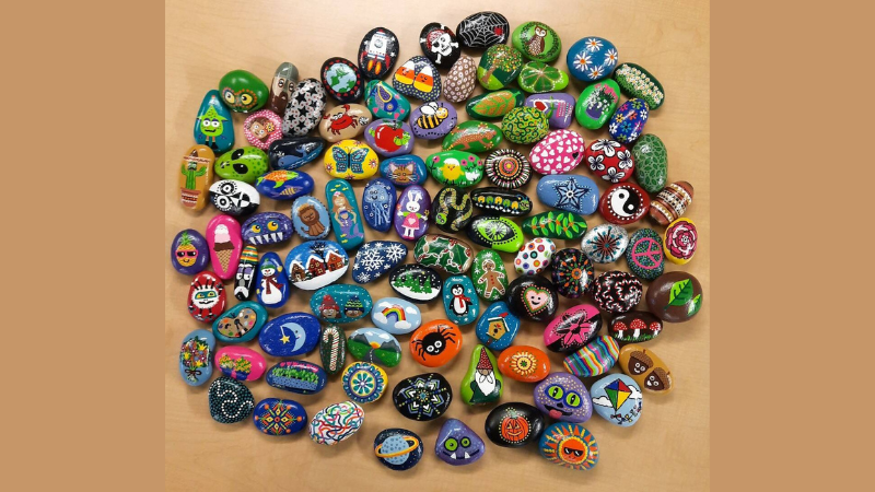 Collection of brightly painted river rocks.