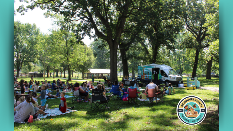 A photo of Story Time at Lincoln Park (2023) with the PPL Bookmobile.
